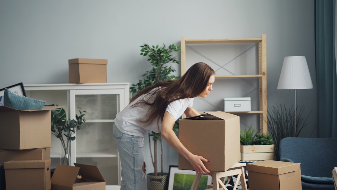 Unpacking boxes in a bright new South Bay living room after a Mike's Moving move